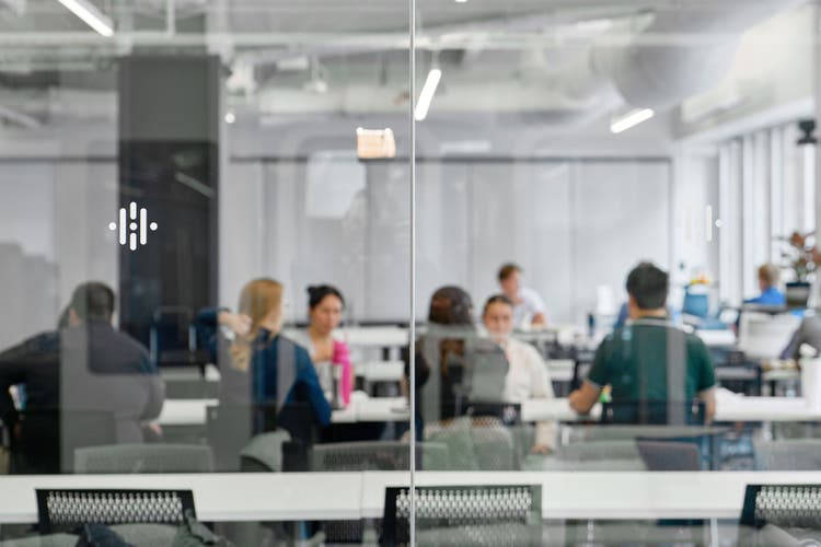 People sitting down at a table in the office