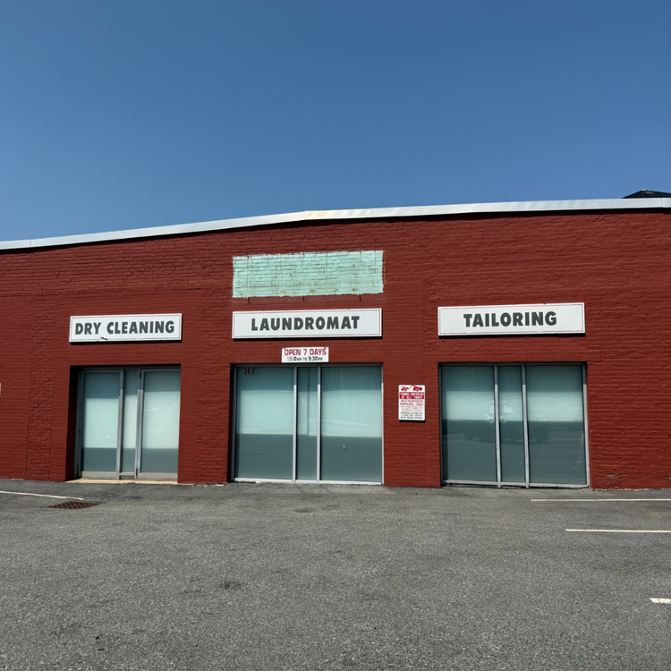 The outside of the Sommeville Office with the signs Dry cleaning , Laundromat and Tailoring