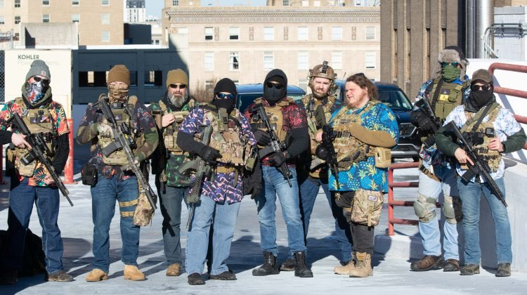 Militia, armed with weapons and wearing Hawaiian shirts and jeans.